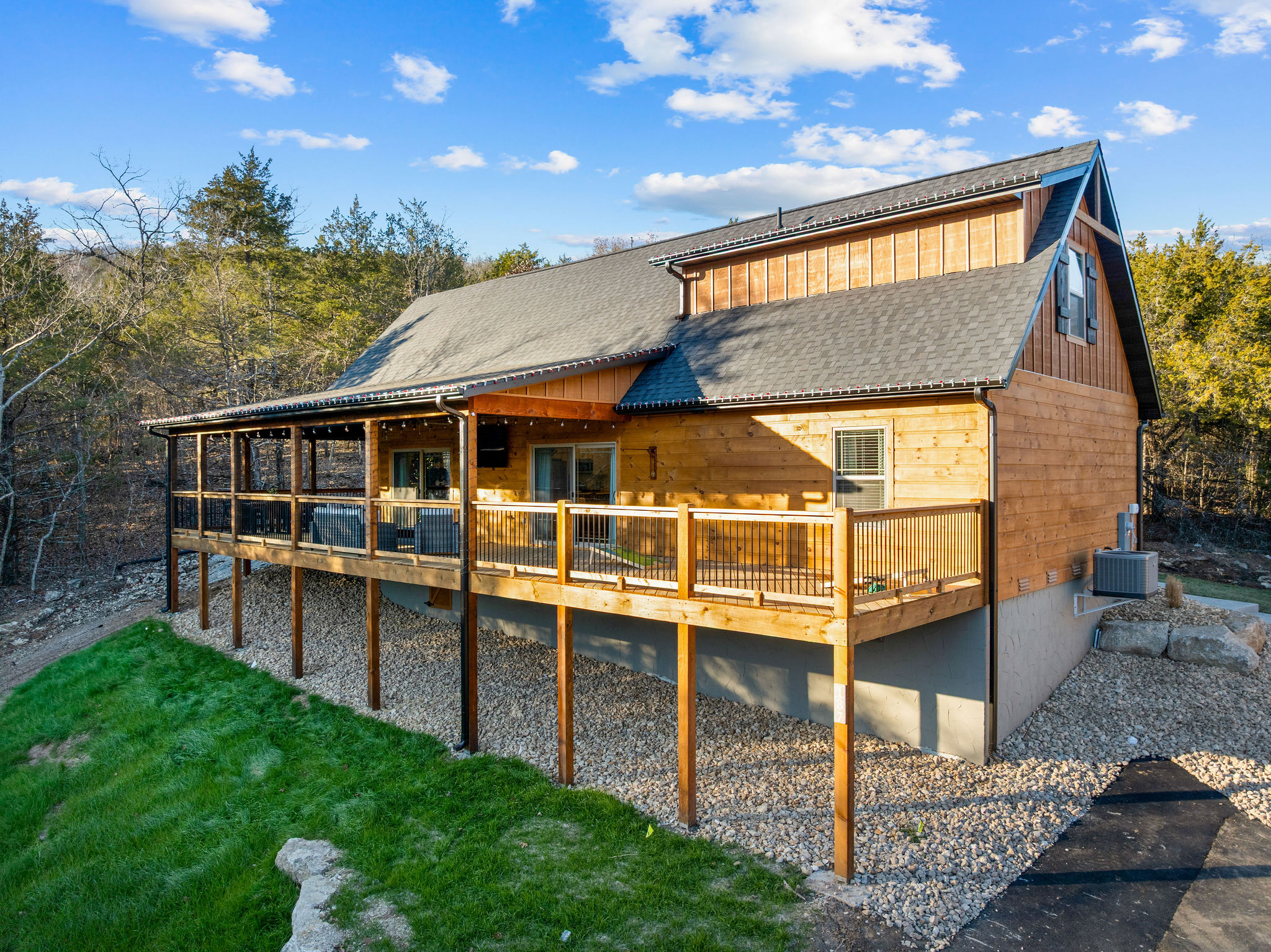 Daytime view of the cabin and its wraparound deck.