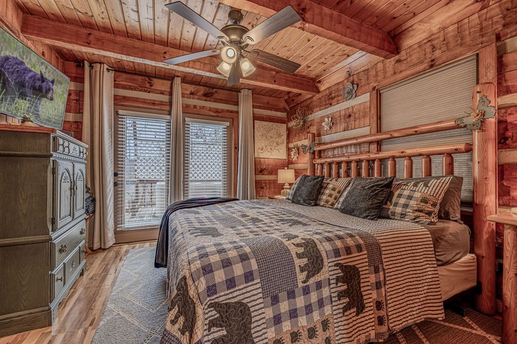 Master suite with plaid bedding and windows