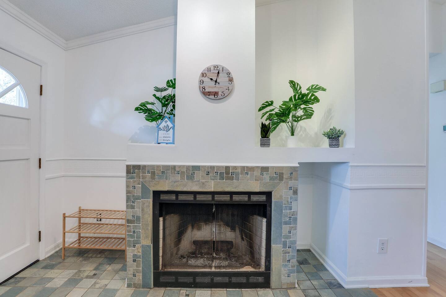 Relax in the bright and spacious living room with high ceilings, abundant natural light from large windows, cozy seating, and a smart TV for your entertainment.