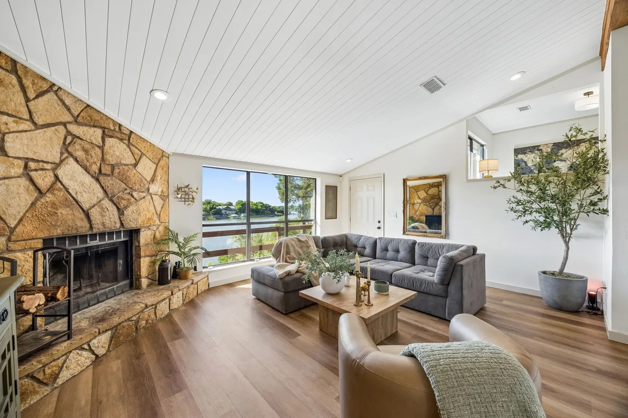 Open living room with fireplace and panoramic lake views.