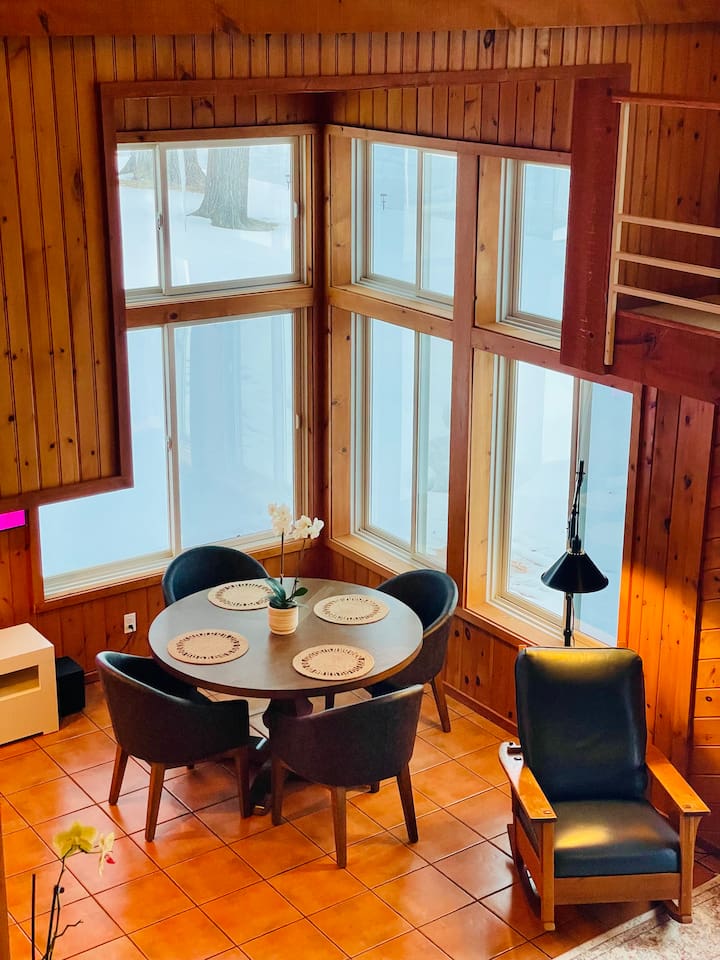 Beautiful breakfast nook surrounded by windows and lake views
