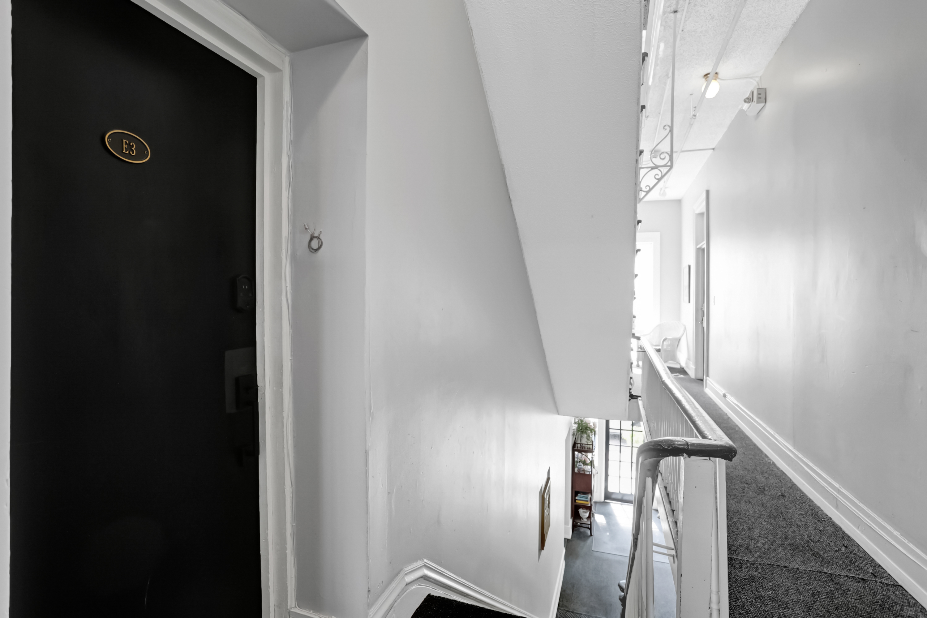 Door to a quiet hallway just off the stairs for easy access.