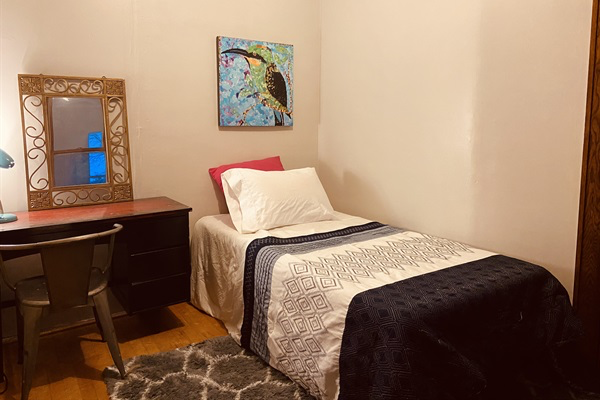 Twin bed, with private workspace.