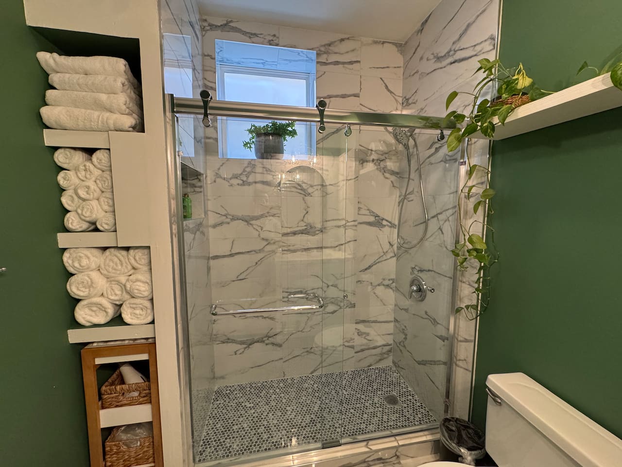 Bathroom with marble tile shower and spa-like design.