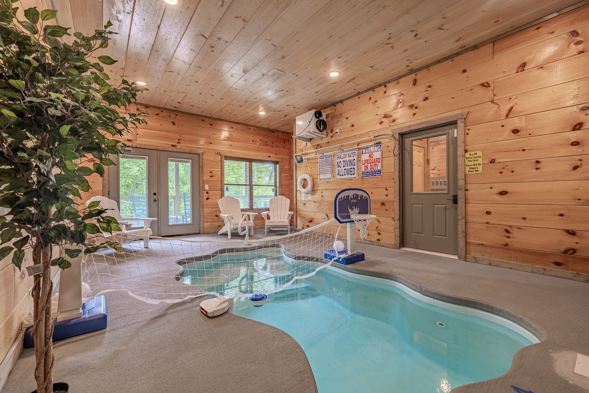 The indoor pool area is designed for family fun, relaxation, and a tropical-inspired escape inside the cabin.