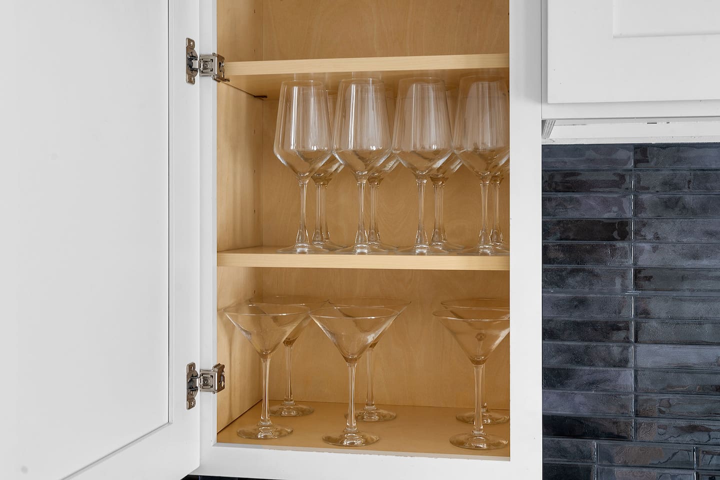 Enjoy a selection of glassware neatly stored in the kitchen cabinet. Whether for wine or cocktails, you'll find the perfect glass for your drink.