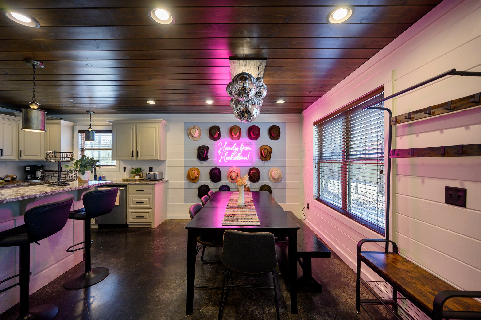 Set the mood for your meals in our playful dining area, featuring a disco ball chandelier and a stylish hat wall!