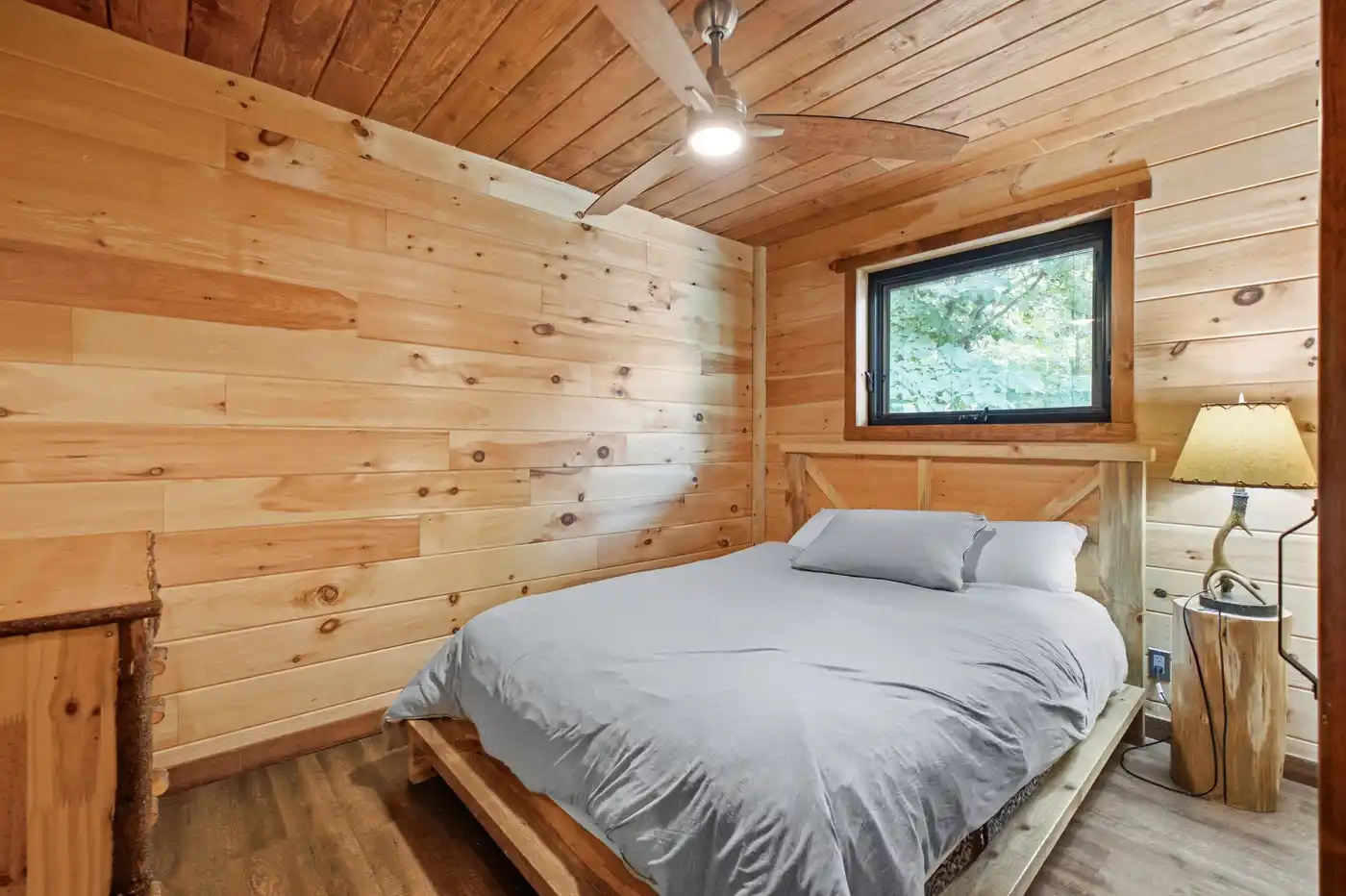 Cozy bedroom with warm wood-paneled walls