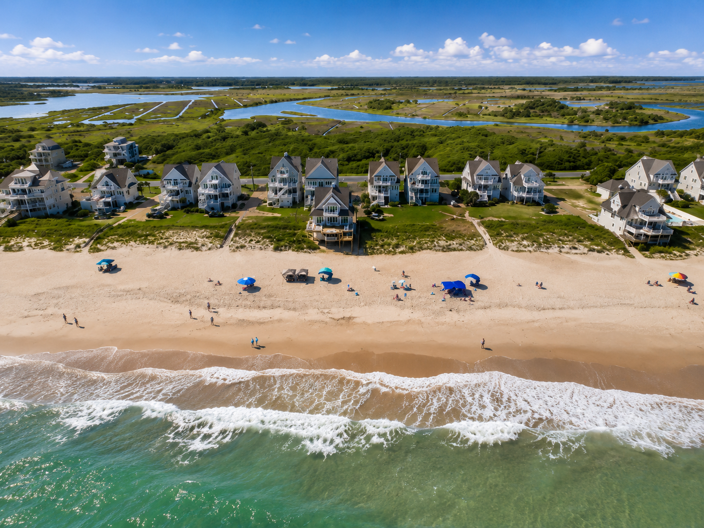 A stunning aerial view showcasing the natural beauty of the beach, ocean, and the peaceful coastal surroundings waiting to be explored.