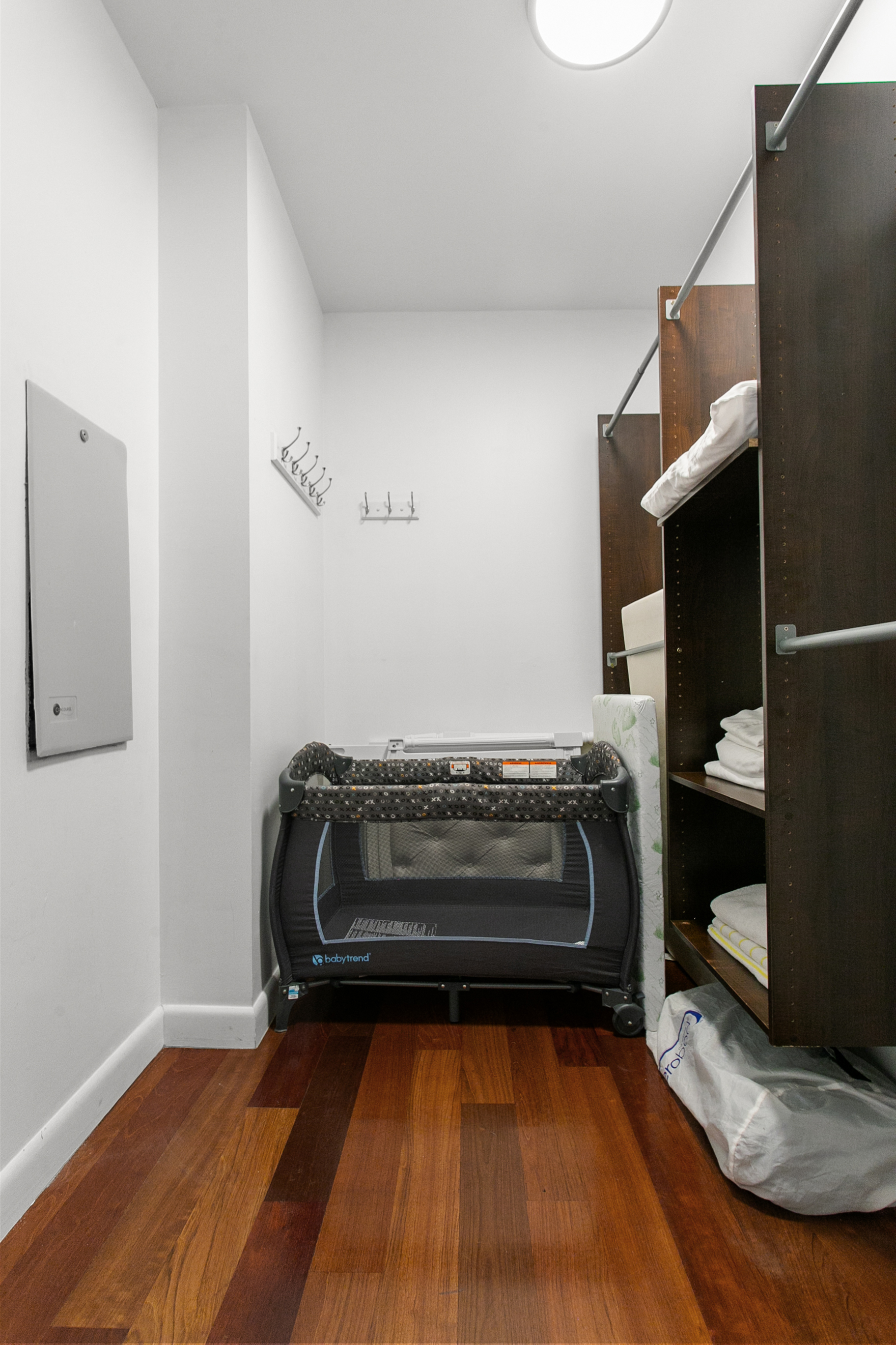 Large walk in closet with baby crib, air mattress and extra linens
