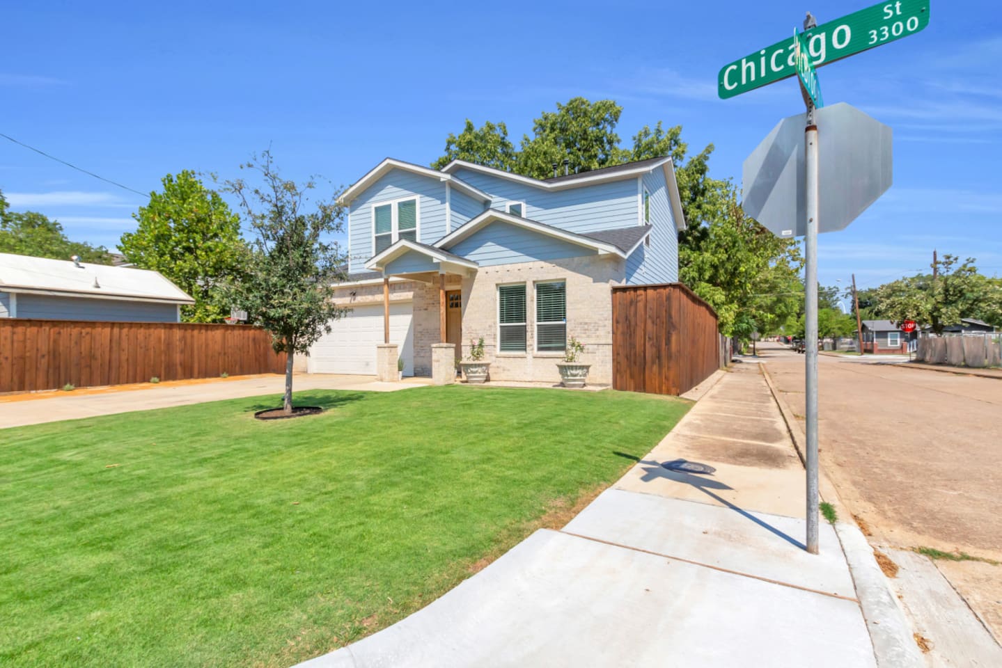 Bright exterior view highlighting modern two-story design.