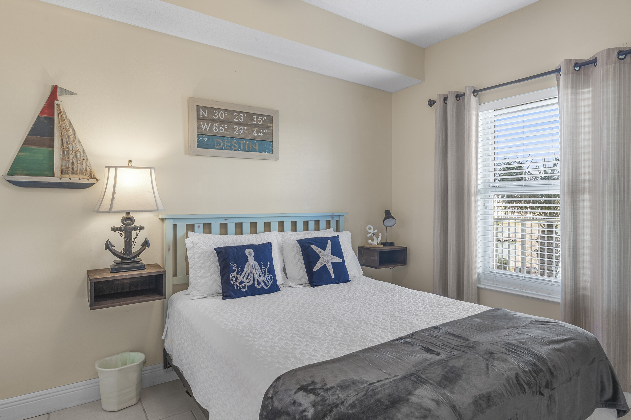 Secondary bedroom with Queen bed, flat screen TV, beachy decor, and private bath