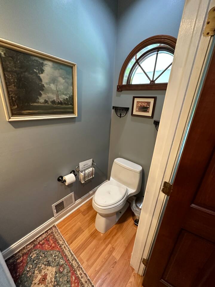 3rd Bathroom which has a sink and toilet (1/2 bath) on the first floor next to the kitchen