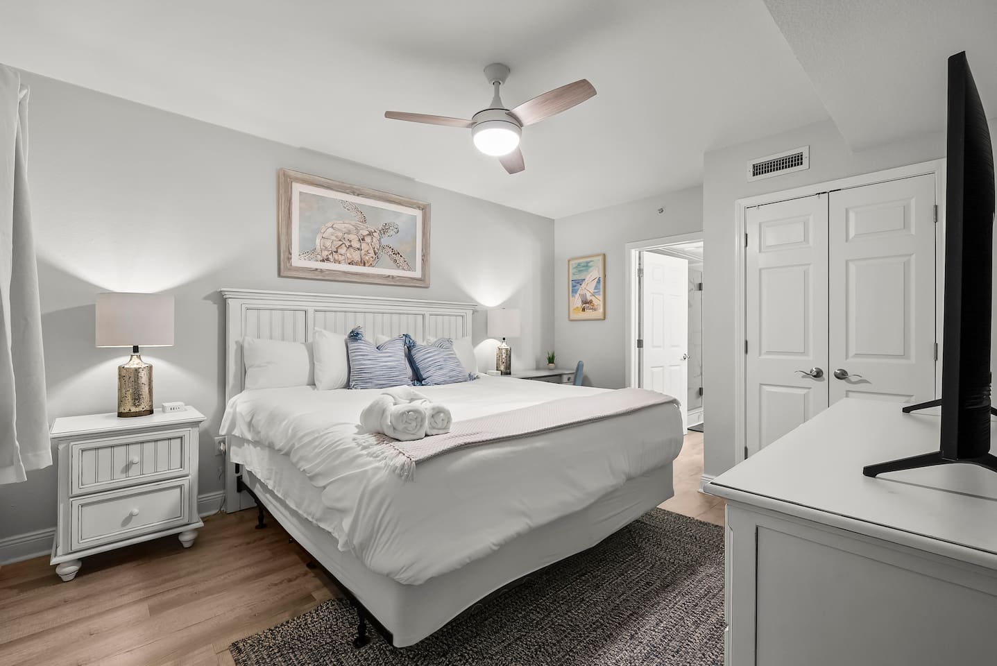 Relax in Coastal Comfort in this serene, beach-inspired king bedroom complete with plush bedding, soft linens, and peaceful decor. Perfect for unwinding after a day in the sun, this calming retreat also features a smart TV and a private ensuite bath.