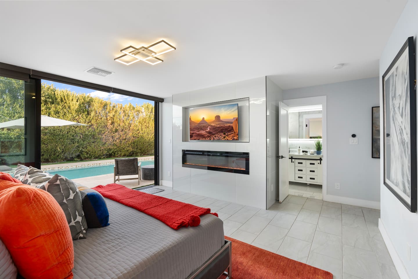 Watch your favorite shows from bed on the wall-mounted smart TV, paired with a sleek electric fireplace for cozy ambiance.

