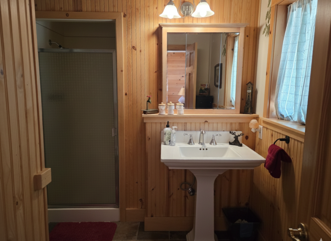 This ensuite bathroom for the second bedroom has a shower, sink, toilet, storage and all of our bathrooms have basic toiletries and linens for your use.