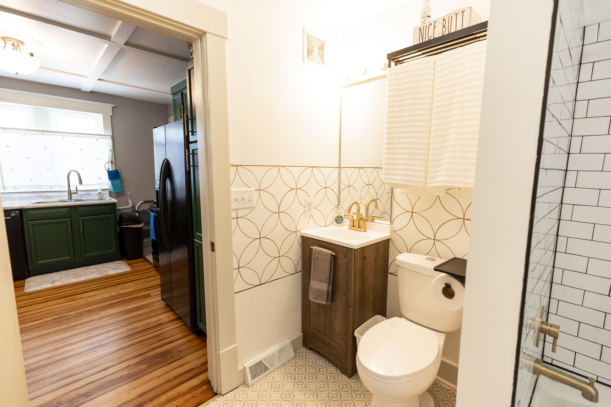 Bathroom off the kitchen and passes through to larger bedroom's walk through closet.