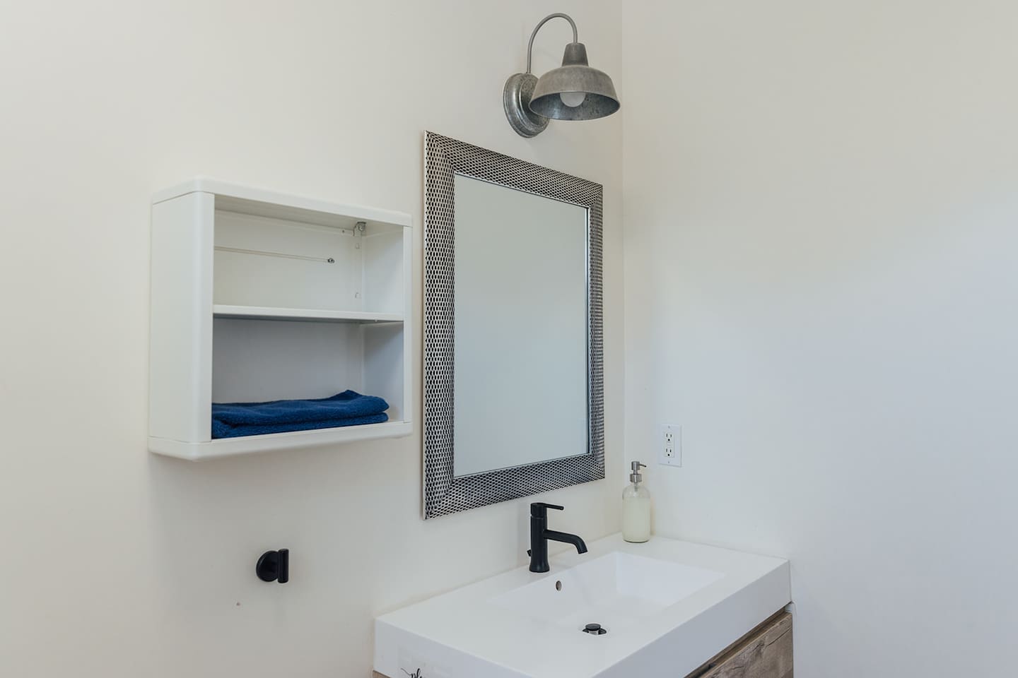 Sink space with shelving and drawers for personal use.