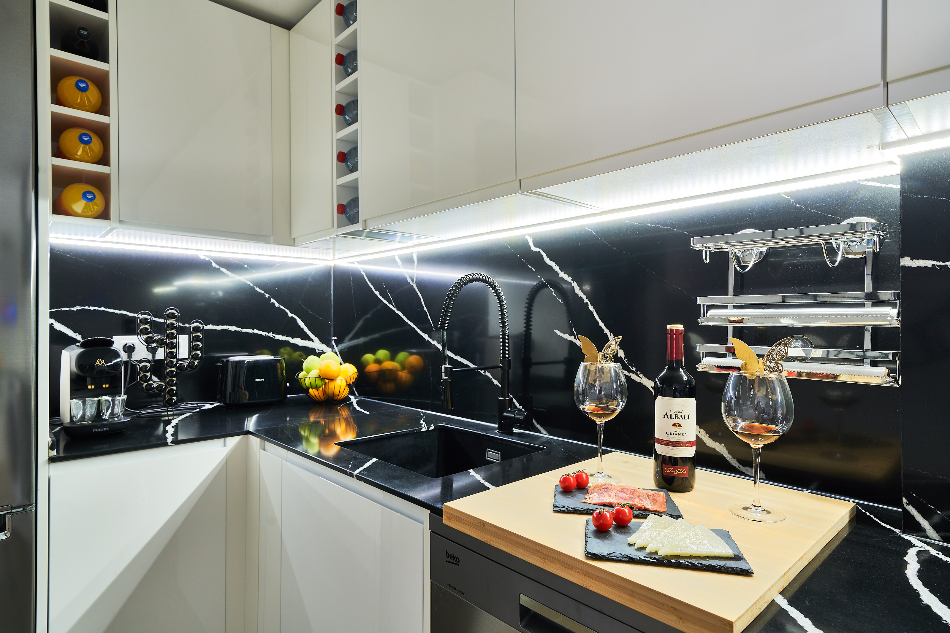 Modern, fully equipped kitchen with high-end appliances, elegant black quartz backsplash, and everything you need for a comfortable stay.