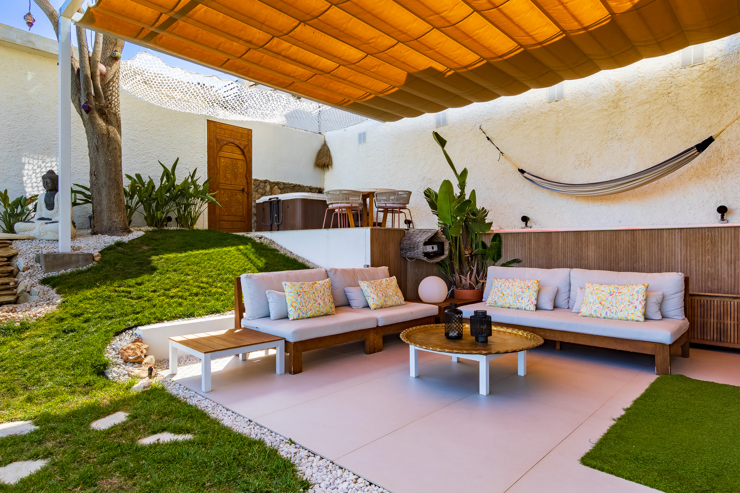 Outdoor cinema lounge with shaded seating and garden atmosphere