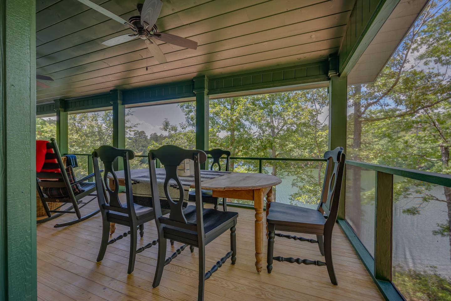 Screened in porch overlooking the lake from the main level of the home
