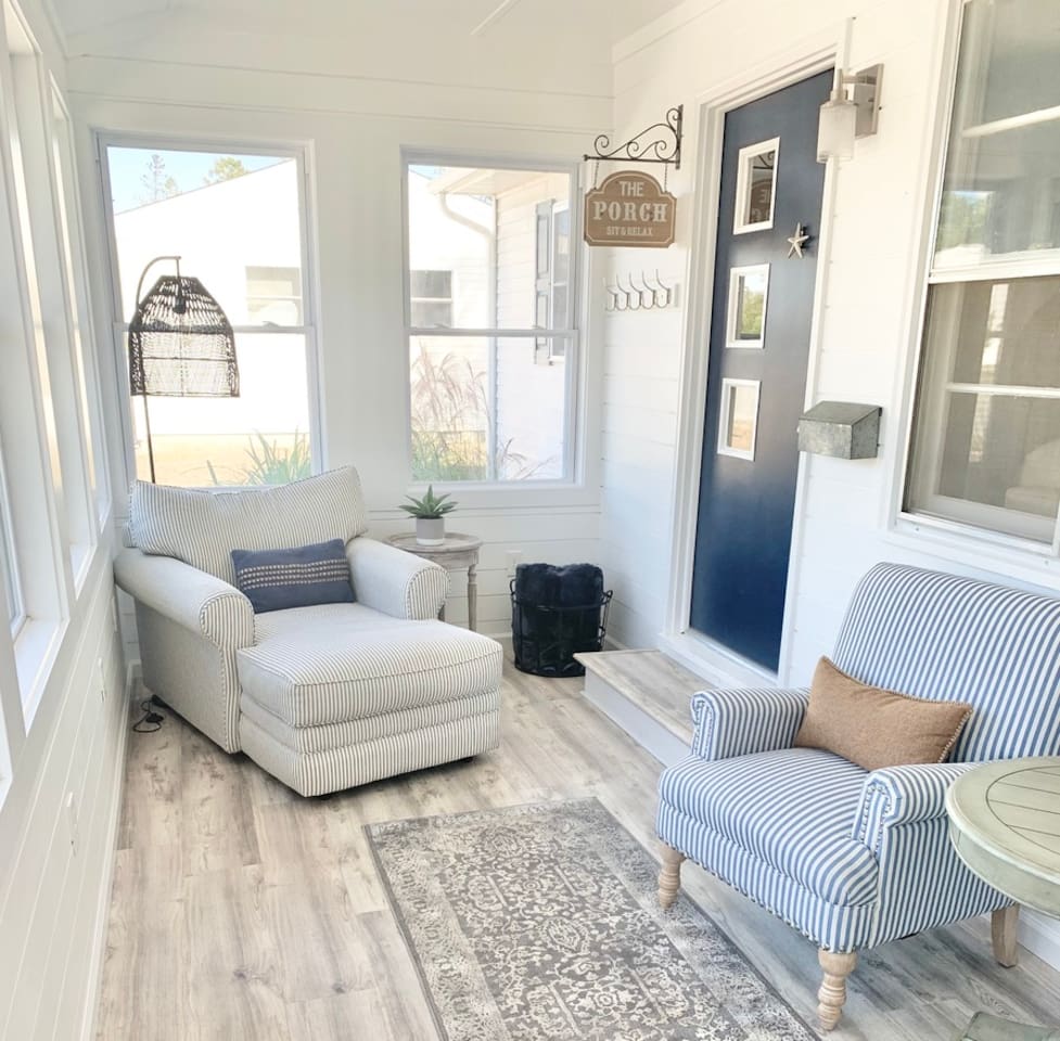 Find your peace in this bright, airy sunroom. Featuring cozy striped armchairs and a comfortable chaise lounge, it’s the perfect spot to curl up with a book, enjoy a quiet morning, or simply soak in the natural light.