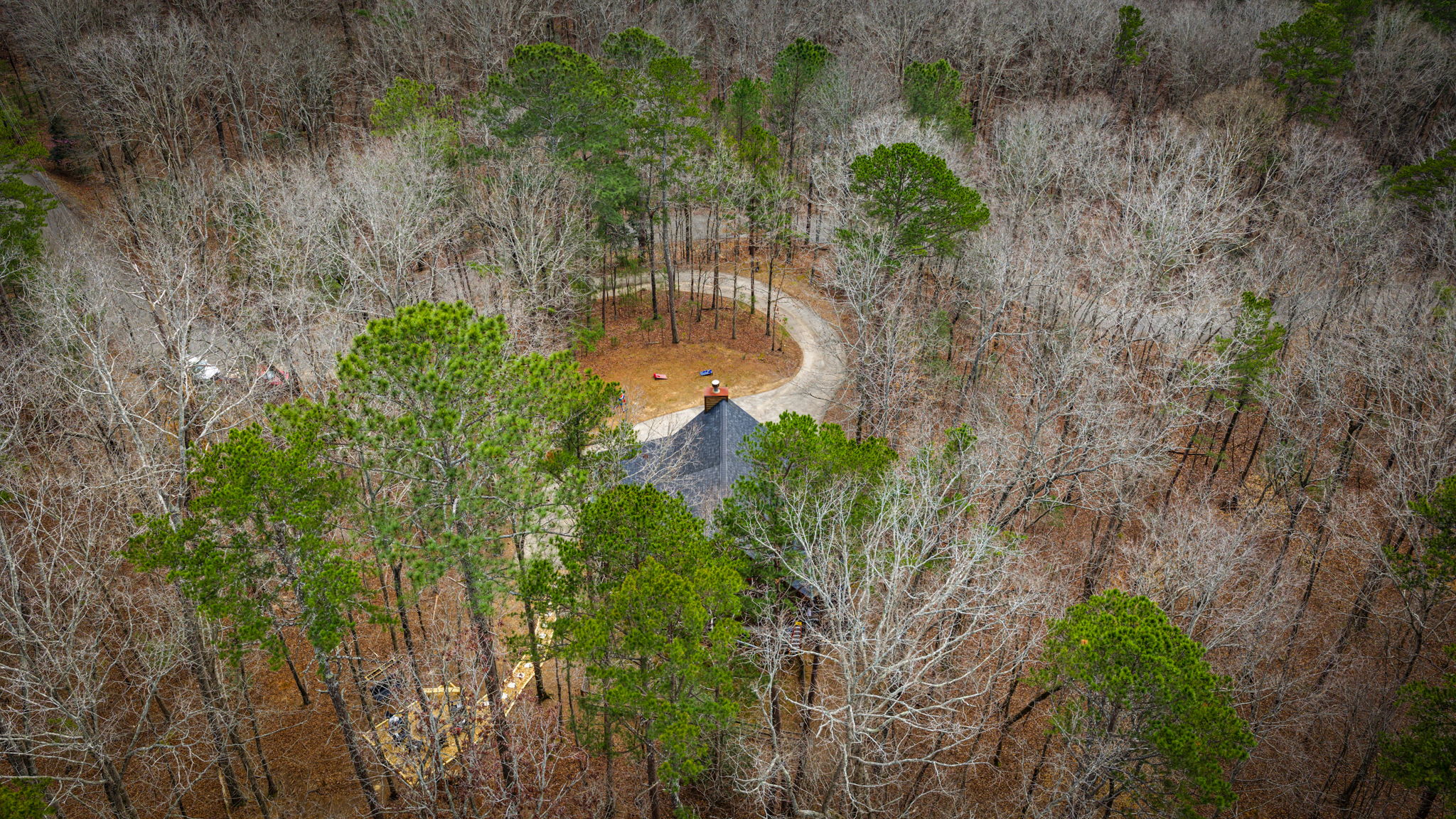 Beautiful aerial shot of the cabin, with the road access.