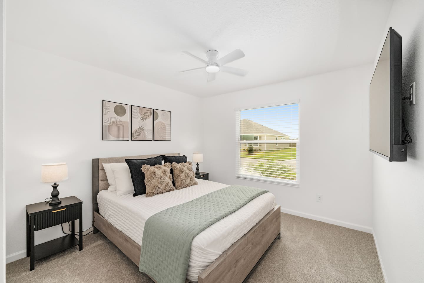 A cozy and inviting guest bedroom designed with comfort in mind. Featuring soft neutral tones, a comfortable bed, and a TV for relaxing nights in after enjoying all that The Villages has to offer.