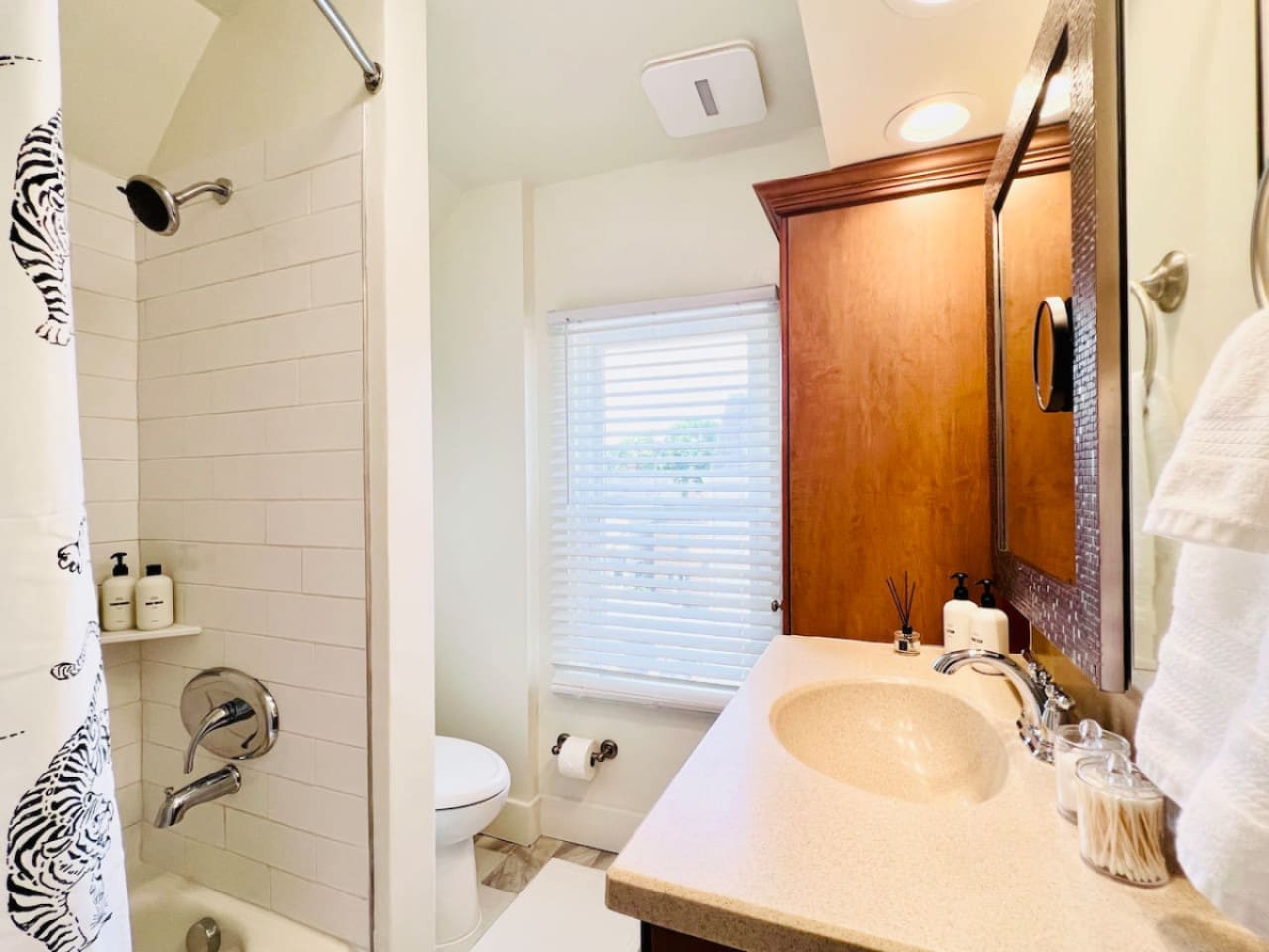Modern full bathroom, featuring sleek fixtures and all the amenities you need for a comfortable and refreshing experience.