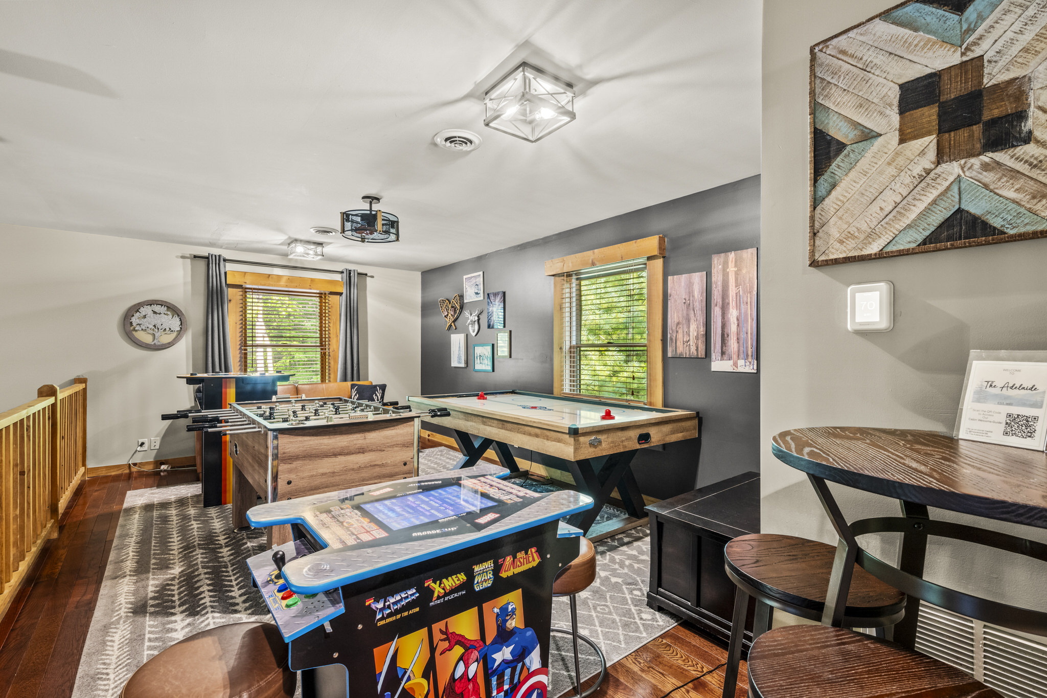 Step upstairs to the lively Game Loft—a guest favorite! Enjoy arcade games, challenge each other at foosball, or unwind on the cozy convertible sofa, which transforms into a bed for extra sleeping space. (Air Hockey table replaced with shuffleboard.)