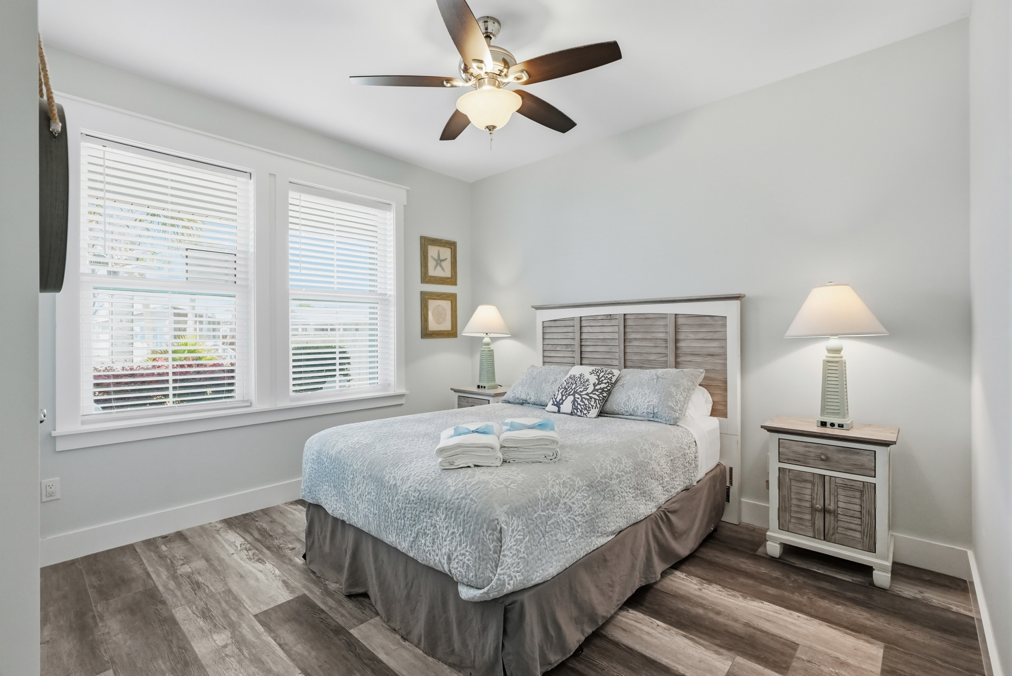 Turn in for the evening in your beach chic Queen bedroom overlooking the front patio, with a built-in closet, overhead fan and charging side shade lamps.