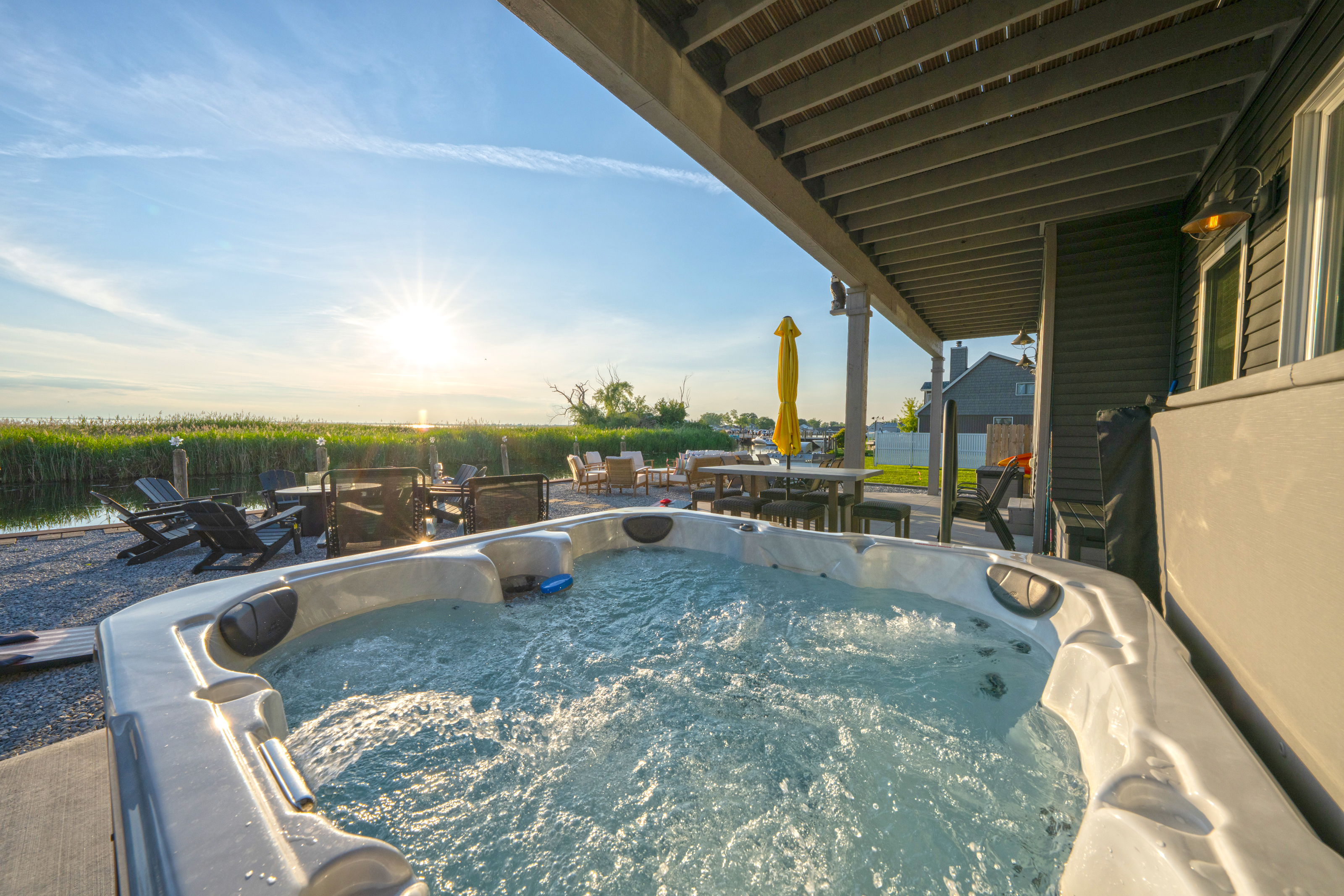 Relax in the private hot tub under the covered patio while enjoying the sunset. The perfect spot to unwind after boating, fishing, or exploring Lake Saint Clair. 