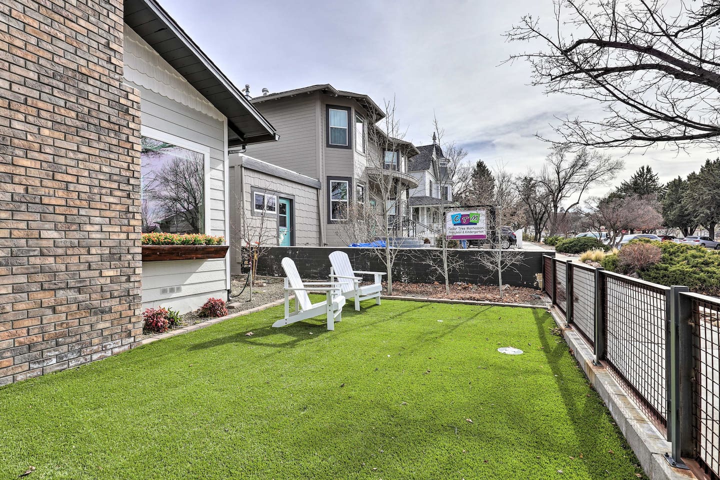 Adirondack chairs on lush turf make for the perfect spot to soak up the sun.