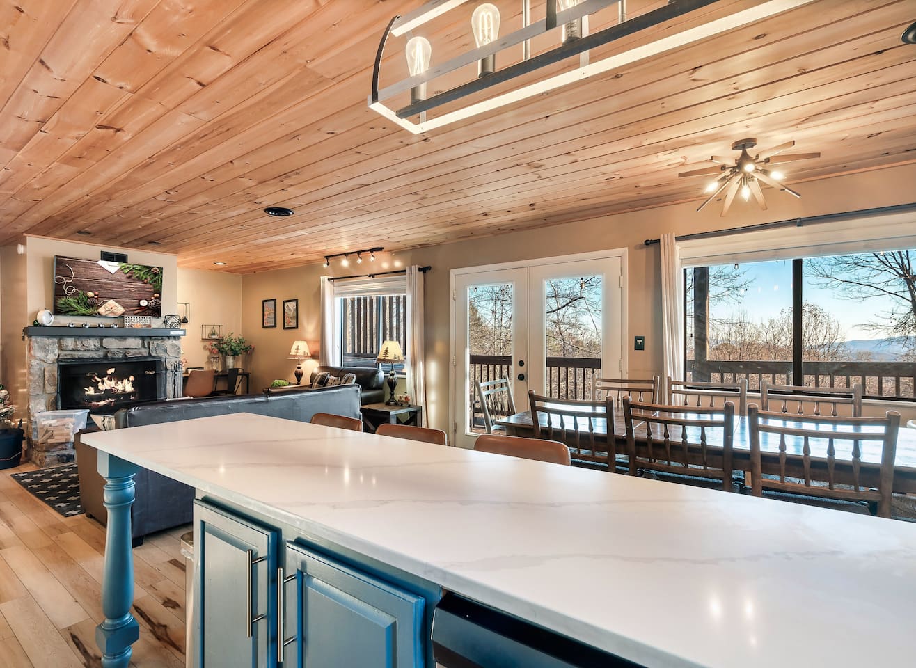 The main floor kitchen, dining area, living area, and deck with seasonal views, BBQ grill and private hot tub.