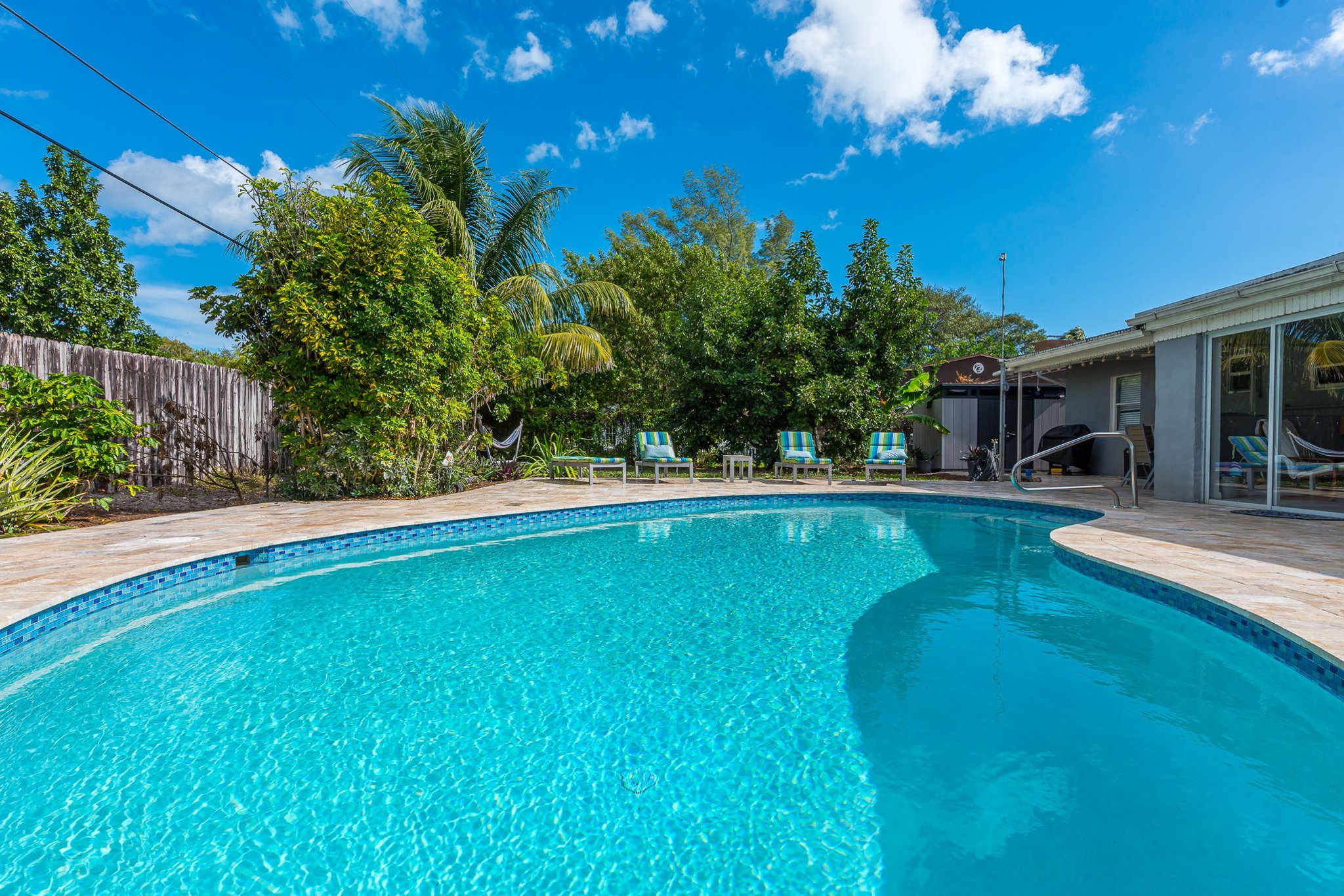 The outside is a highlight, with the heated pool, outdoor sun- loungers, BBQ and covered dining area.