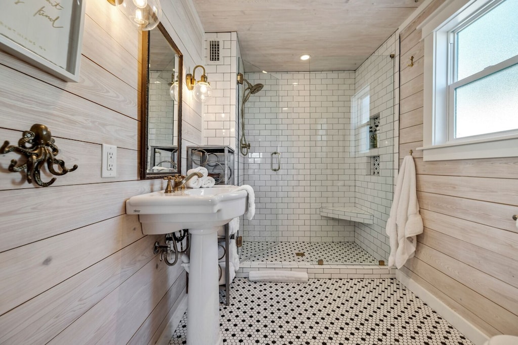 One of two large walk-in showers with delta showerheads that include removeable handheld showers.