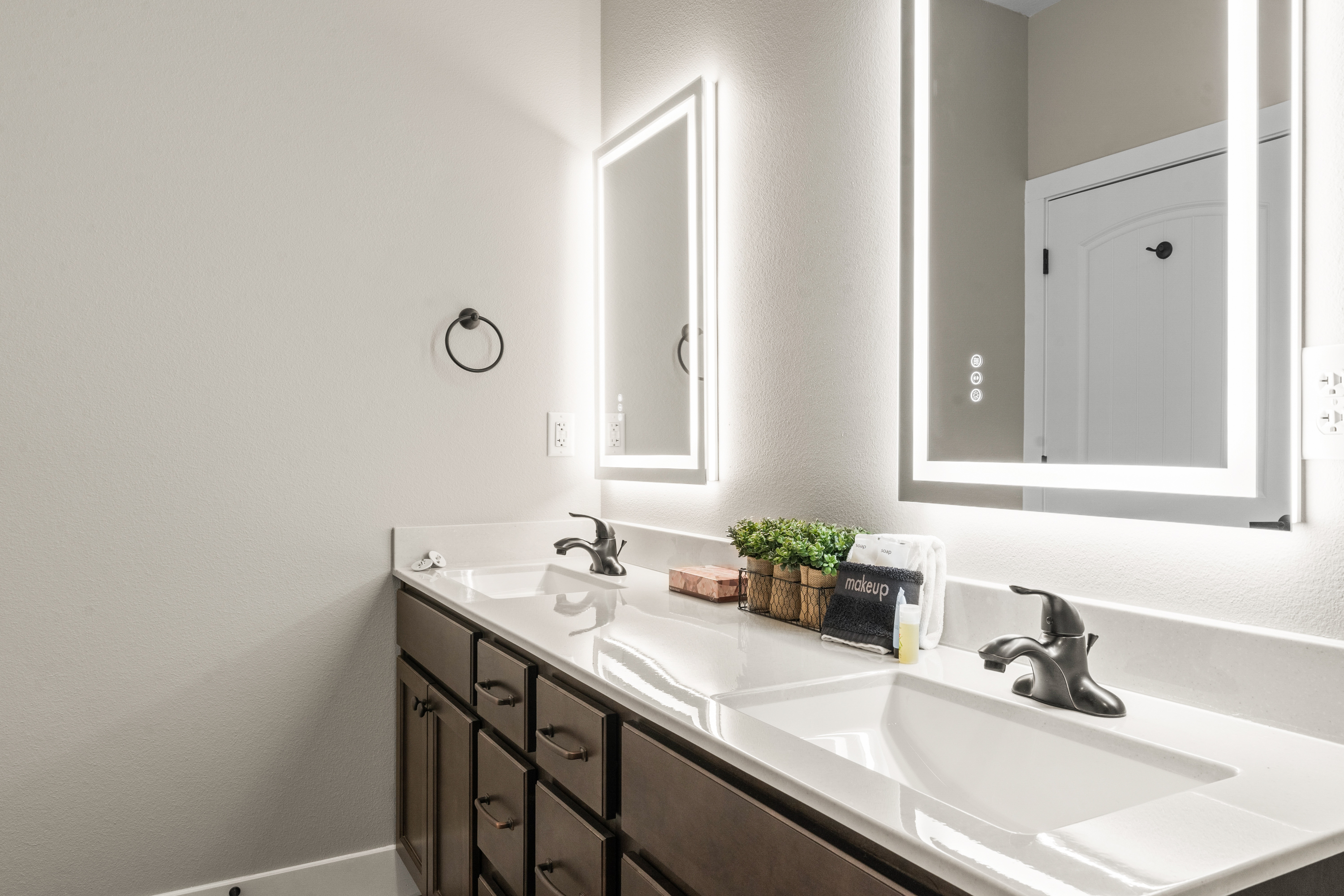 Master Bathroom #2 has his and her sinks with lighted mirrors to get ready for a night on the town. The mirrors also have an anti-fog feature.