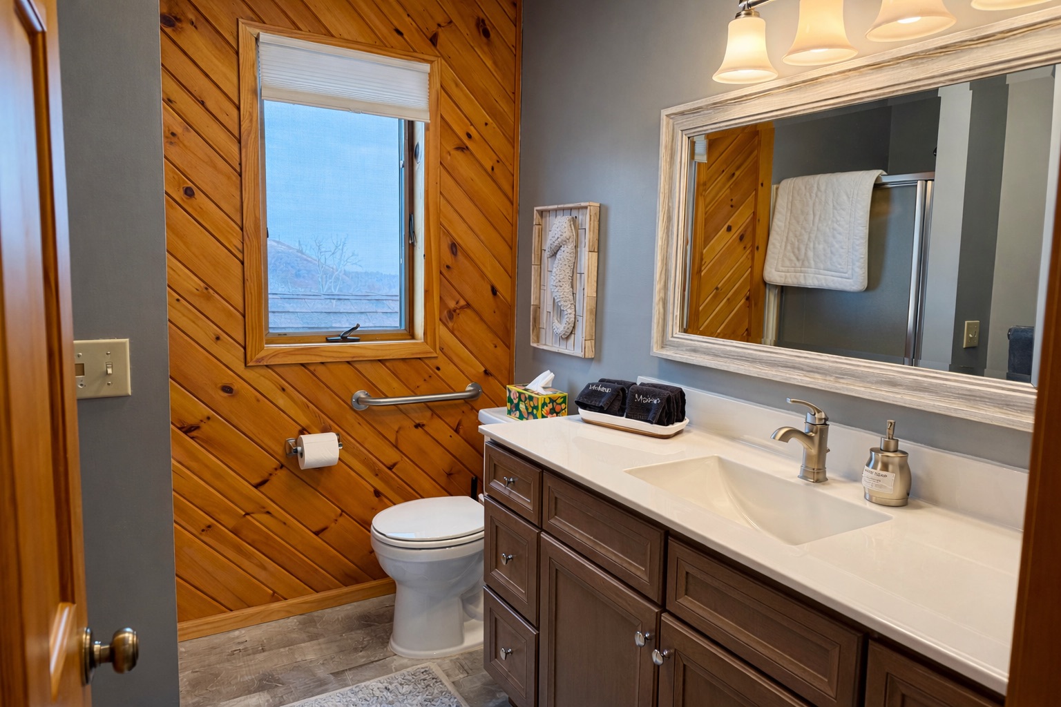 The main floor bathroom is bright, open, and beautifully updated, clean lines, fresh finishes, and plenty of light. A calm, modern space to refresh and recharge after a day exploring the North Shore.