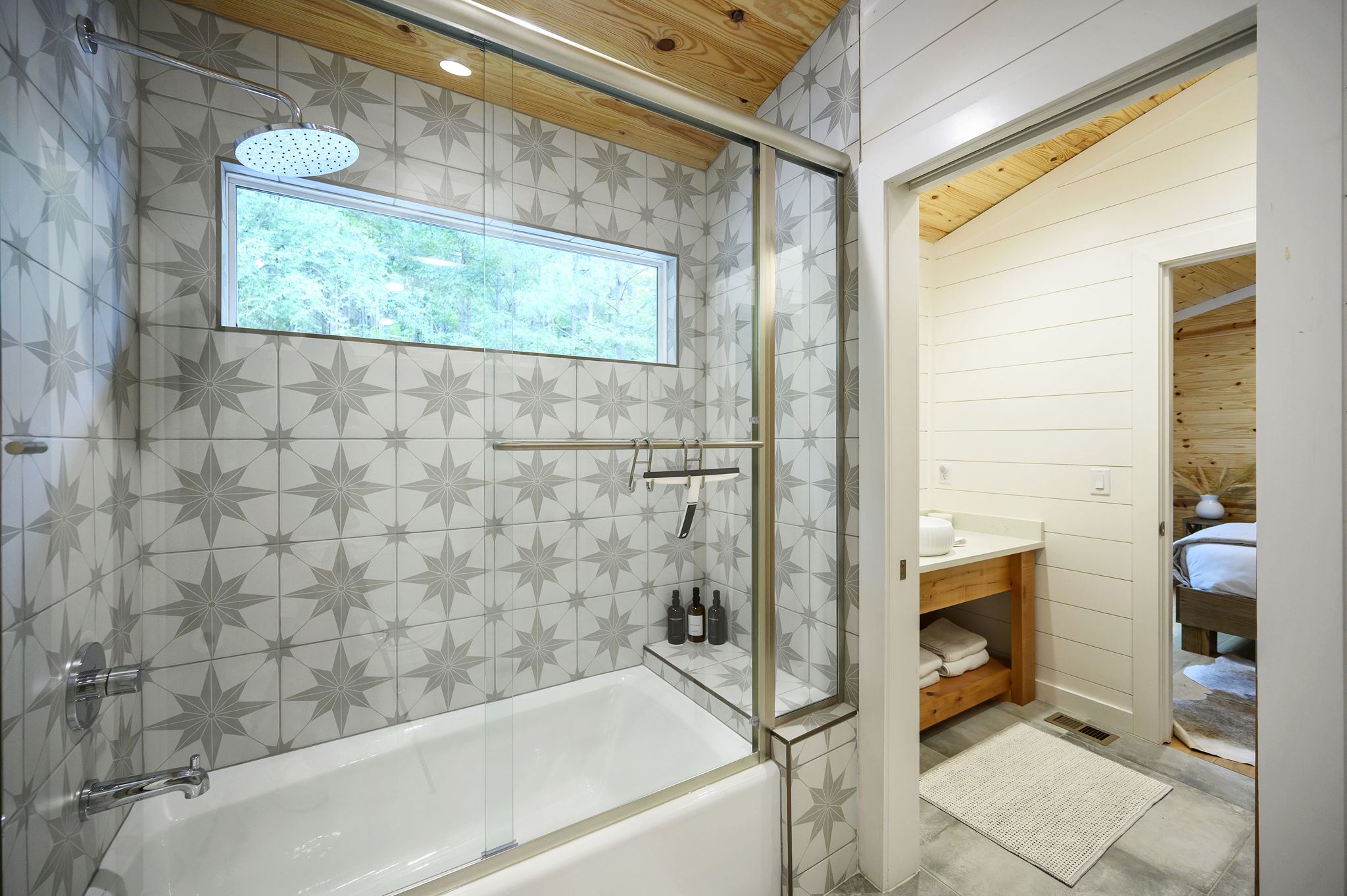 The shared full bathroom offers a cozy, spa-like feel with luxury finishes, warm design details, and everything guests need to feel comfortable and refreshed.