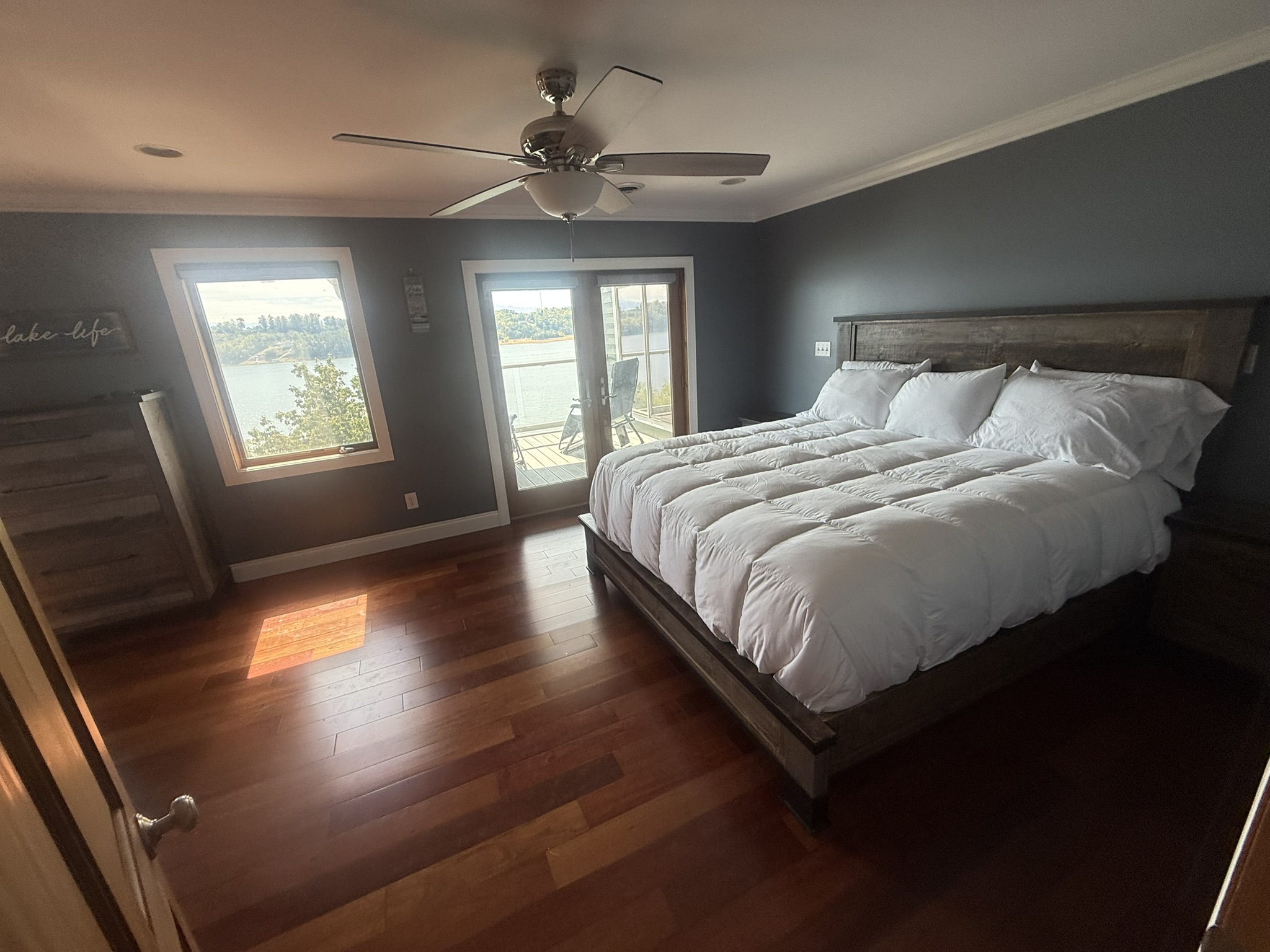 Bedroom 1 with King Bed, private covered porch, and beautiful view of Douglas Lake