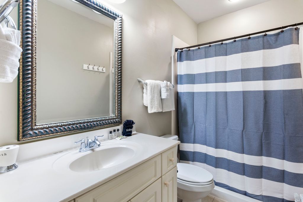 First Floor: Bathroom 1 – Spacious full bathroom featuring a walk-in shower.