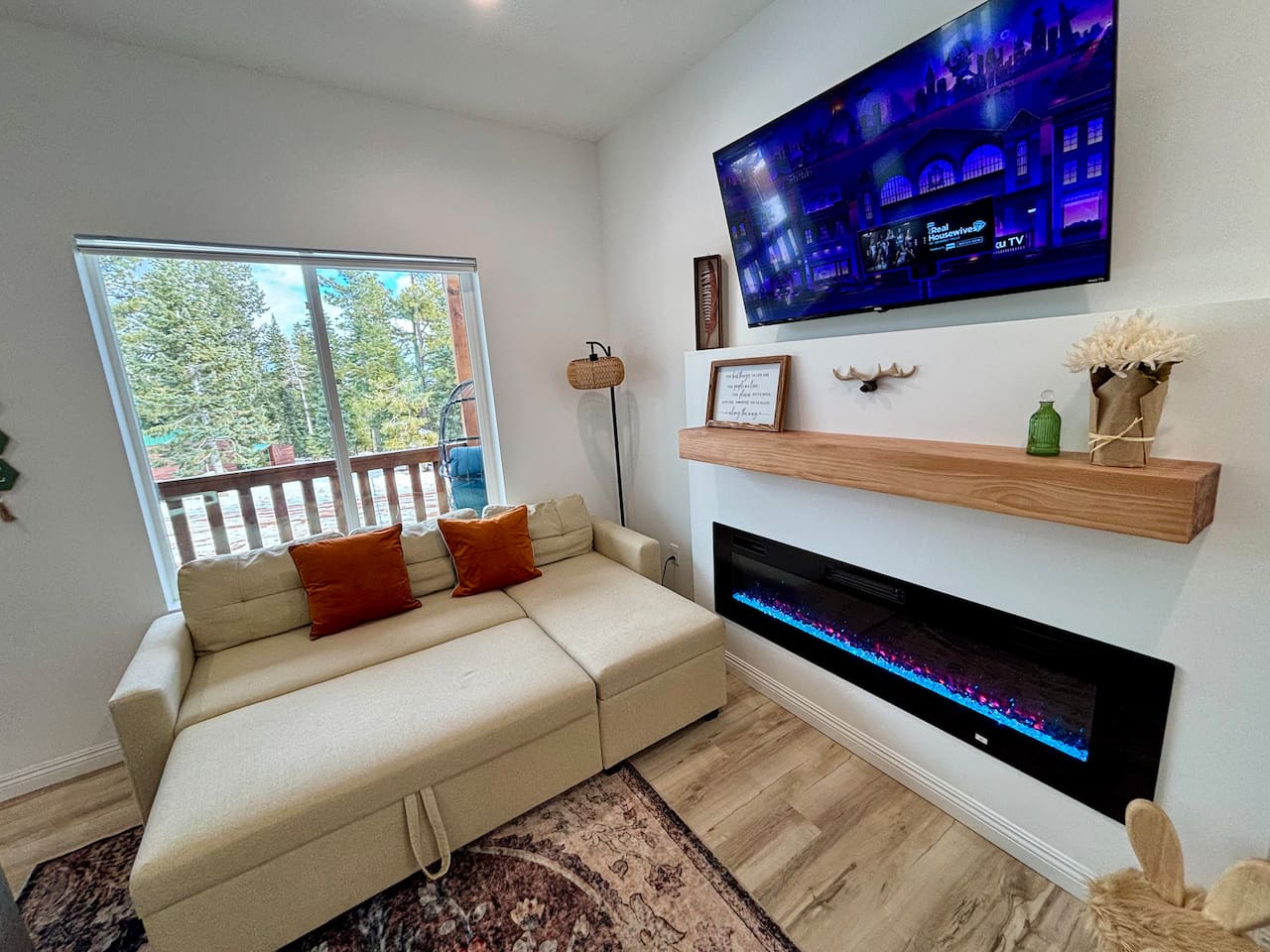 Movie night by the fire hits different here — the sofa pulls out into a comfy bed, perfect for extra guests.