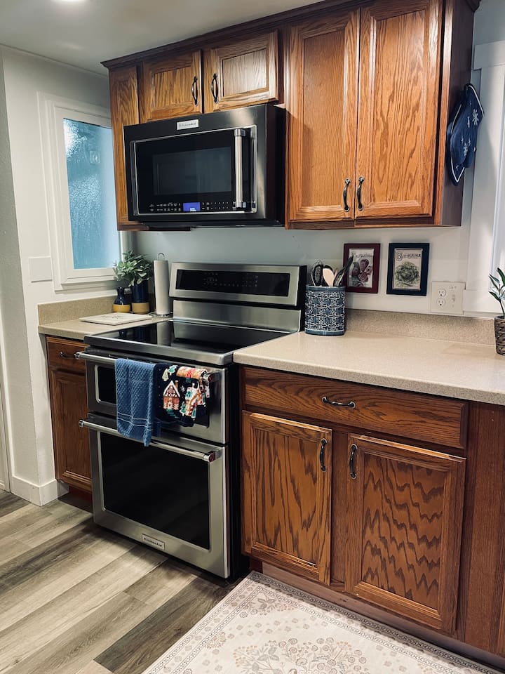 An induction cooktop brings water to a boil in moments, paired with a split double oven and built-in microwave for effortless, efficient cooking.