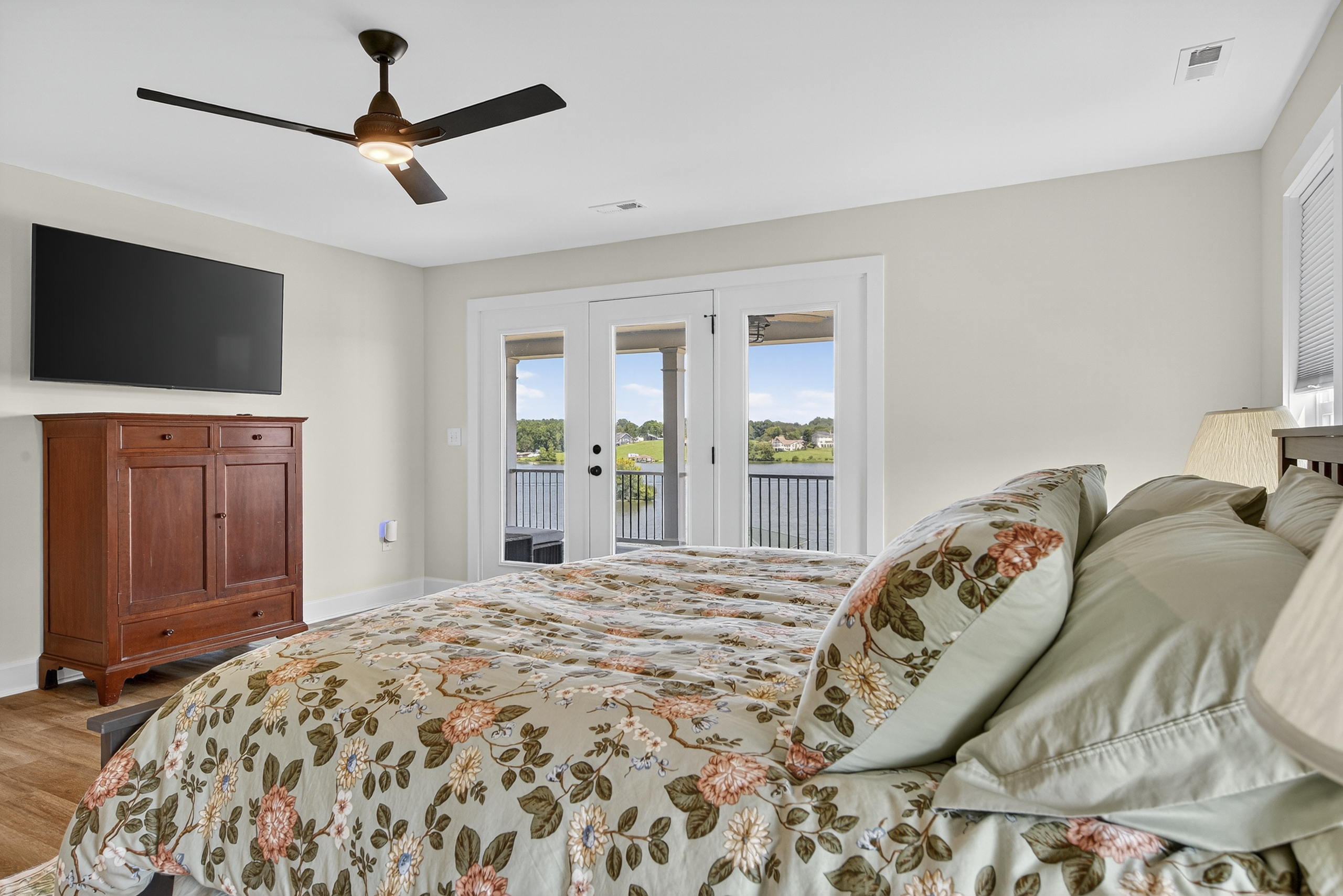 Stretch out and unwind in this serene king suite featuring a plush bed, private sitting area, and direct access to the wraparound porch.