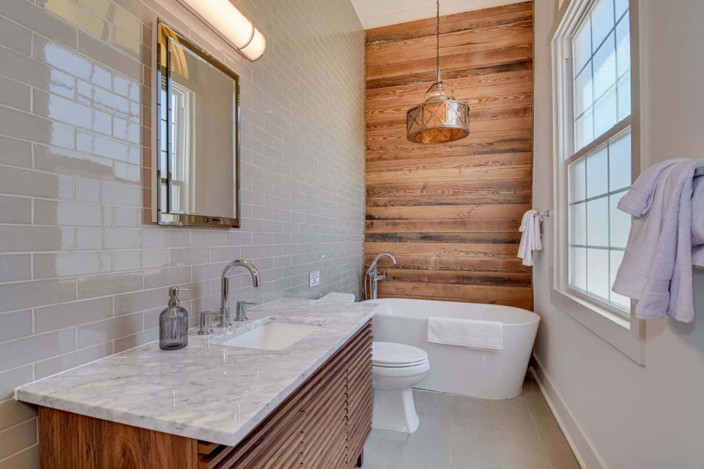 Full bathroom with large bath tub and modern finishes.