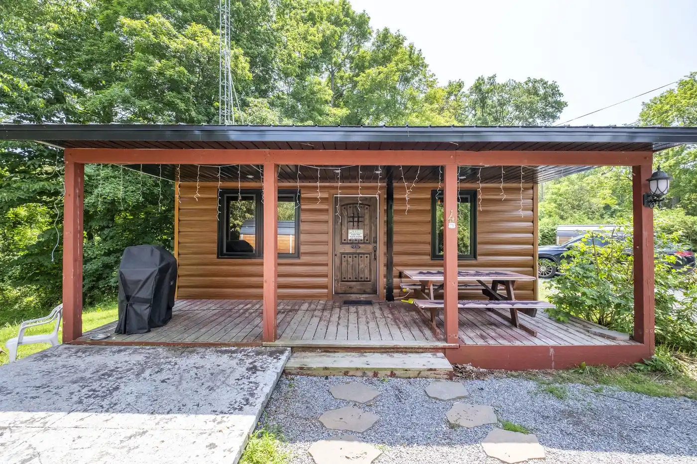 Front view of Cottage #4 with covered porch and patio area
