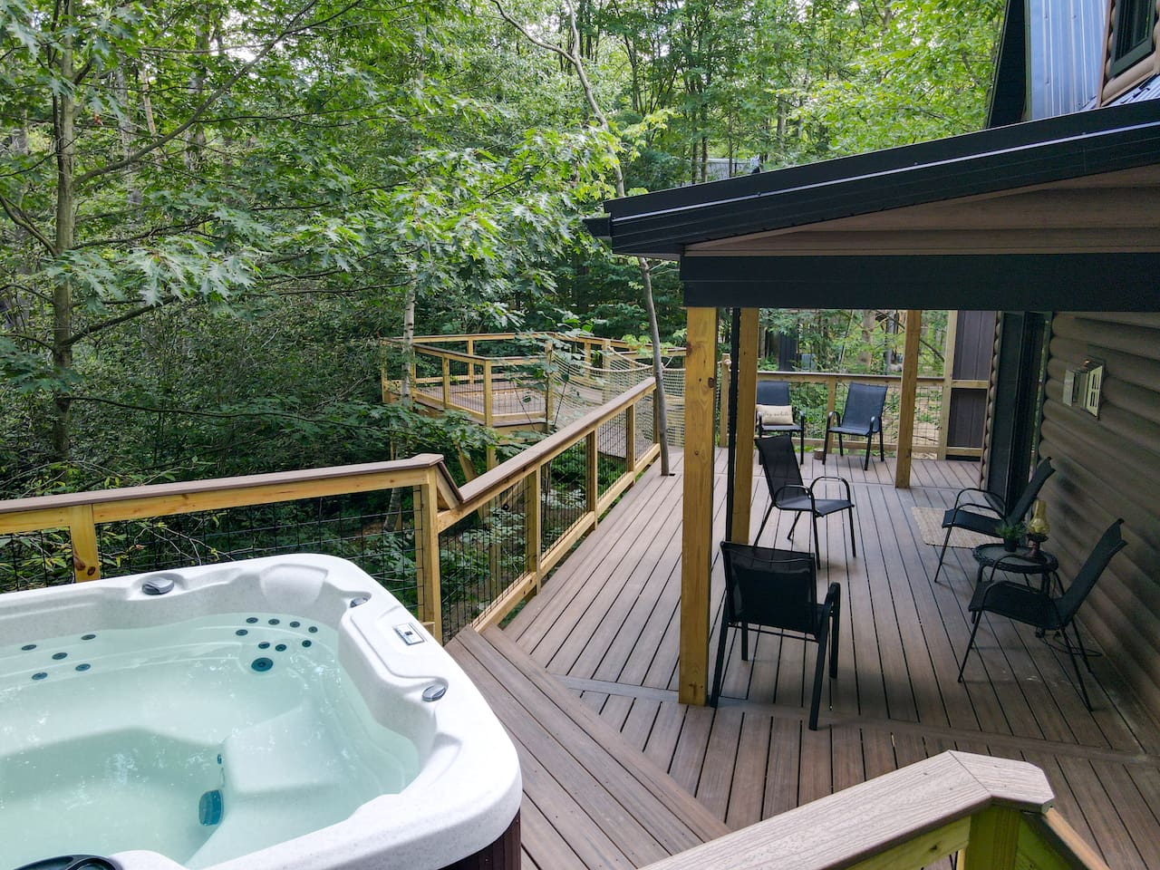 The treehouse deck offers a luxurious outdoor experience with an elevated hot tub & XL hammock seamlessly built into the deck floor. Additionally, you can enjoy the refreshing outdoor shower May 15- October 15. The hot tub is available 365 days 24/7.