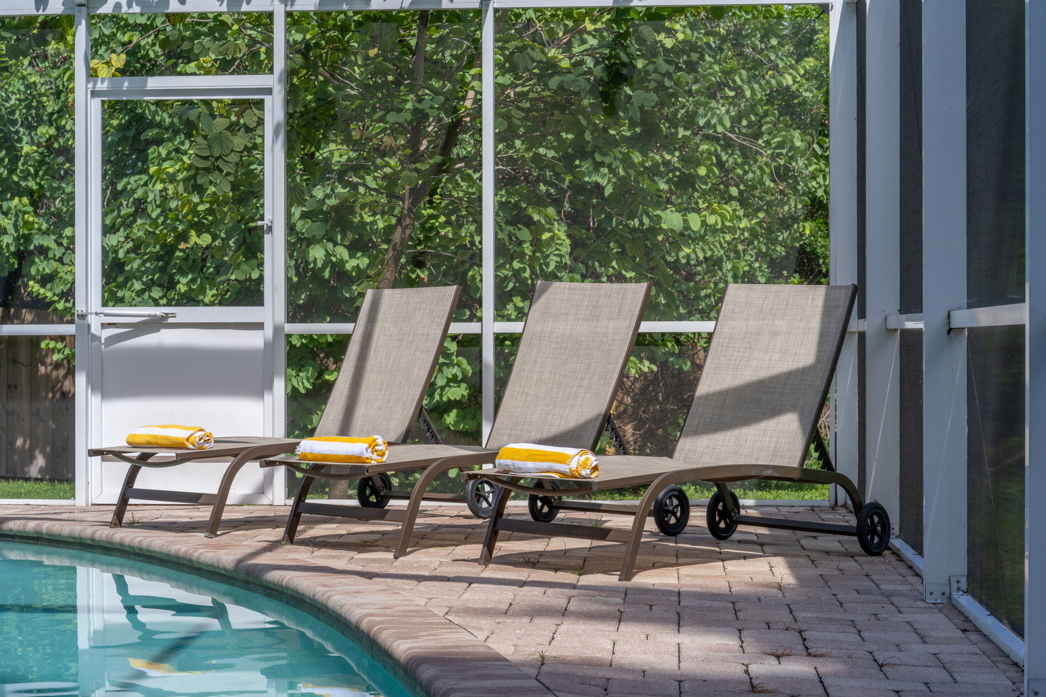 Spacious pool deck with plenty of room for gatherings and outdoor dining.