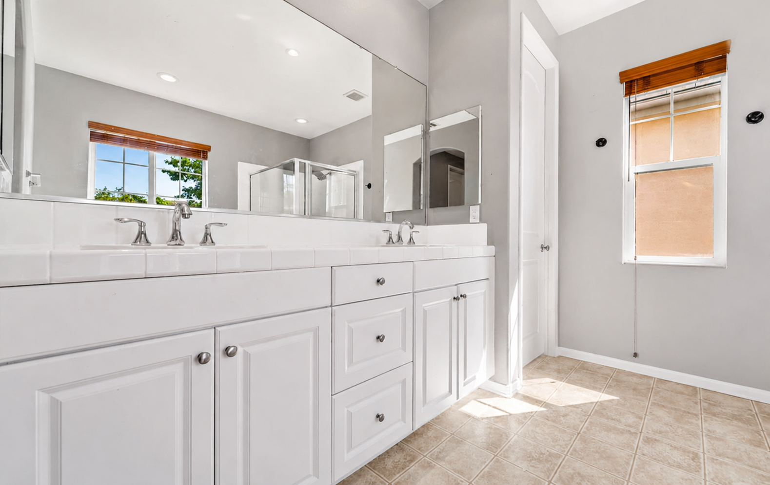 Primary bathroom vanity with double sinks, lots of counter space, and a clean setup for getting ready.