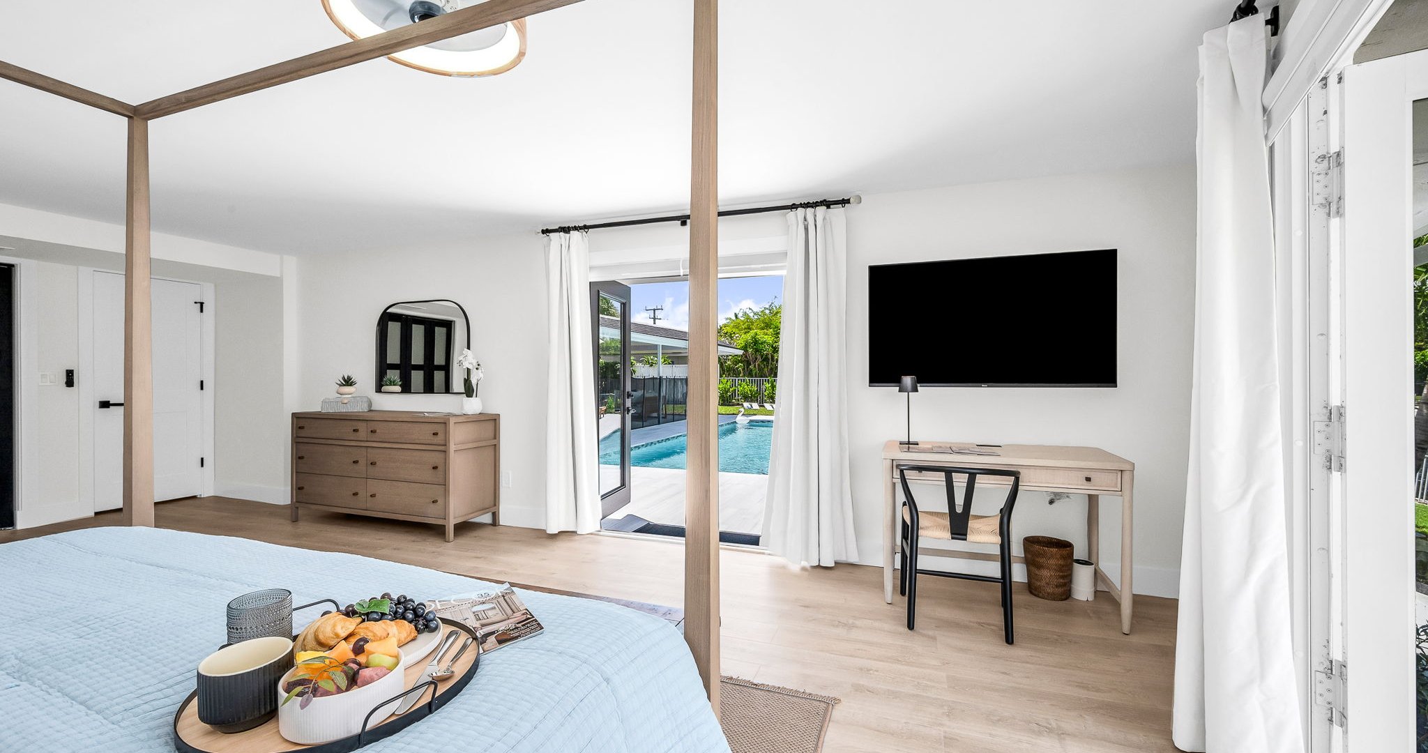 The primary king suite feels like your own private resort—featuring panoramic views of the pool and lake, seamless indoor-outdoor flow, and a newly renovated spa-inspired ensuite. Thoughtfully styled with designer finishes.
